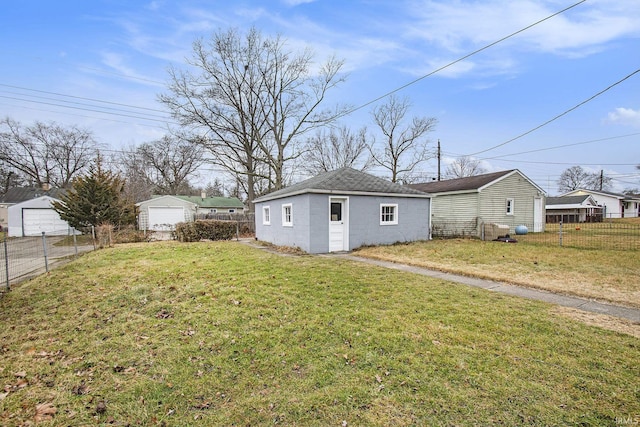 view of home's exterior featuring an outdoor structure and a lawn