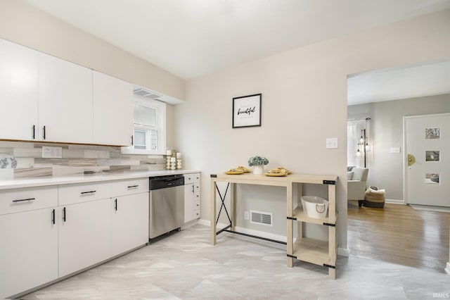 kitchen featuring dishwasher, backsplash, light hardwood / wood-style floors, and white cabinetry