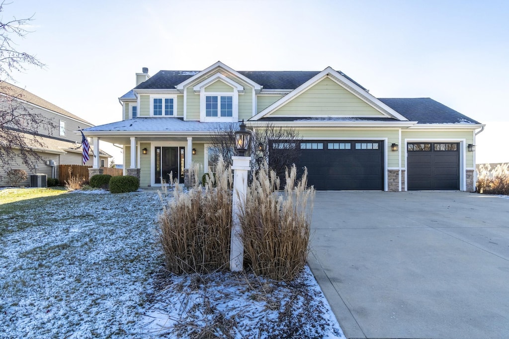 view of front of house featuring a porch and a garage