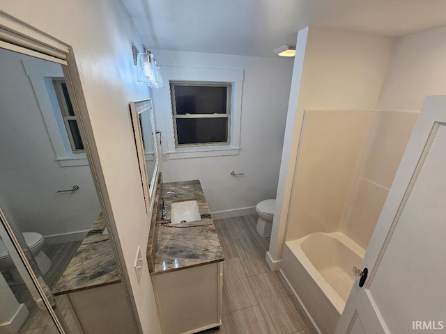 bathroom with hardwood / wood-style flooring, vanity, and toilet