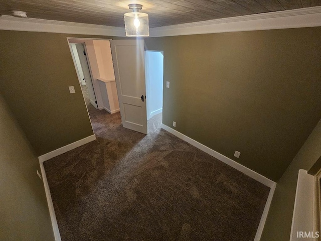 carpeted empty room featuring crown molding and wooden ceiling