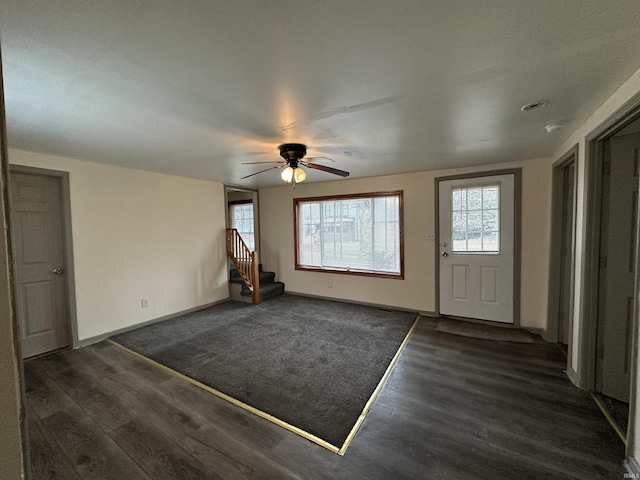 entryway with dark hardwood / wood-style floors and ceiling fan