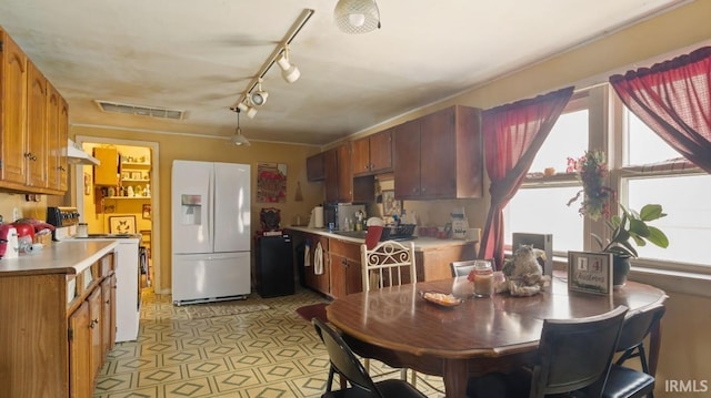 kitchen featuring white appliances and rail lighting