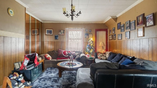 living room with a chandelier, wooden walls, and ornamental molding