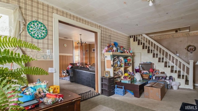 interior space with plenty of natural light, carpet floors, crown molding, and an inviting chandelier