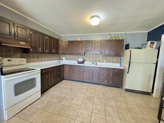 kitchen featuring backsplash, dark brown cabinetry, sink, and white appliances