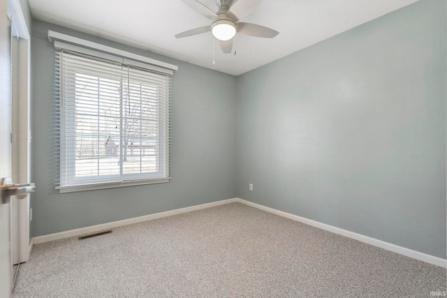 empty room with light carpet, ceiling fan, and a healthy amount of sunlight