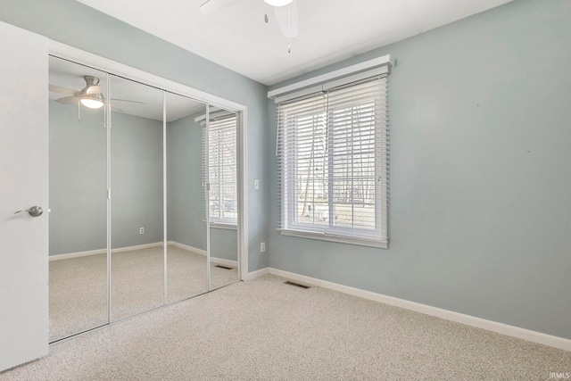 unfurnished bedroom featuring carpet, a closet, and ceiling fan