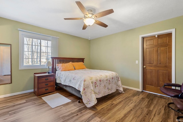 bedroom with wood-type flooring and ceiling fan