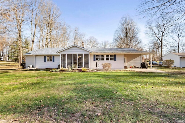 rear view of property with a sunroom and a yard