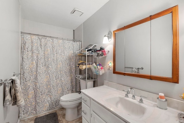 bathroom with tile patterned floors, vanity, and toilet