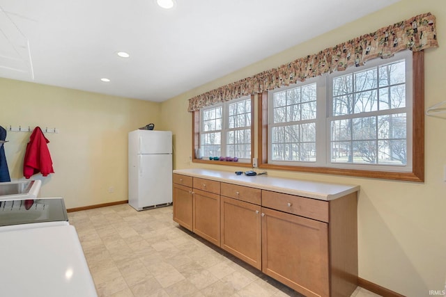 kitchen with white fridge and a wealth of natural light