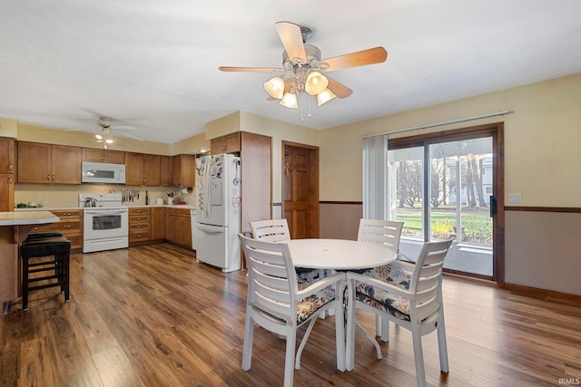 dining room featuring ceiling fan and dark wood-type flooring