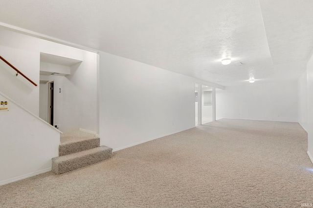 interior space featuring carpet flooring and a textured ceiling