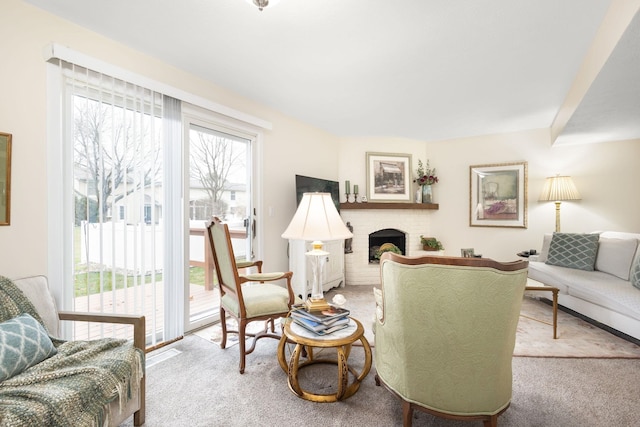 living room with carpet flooring and a brick fireplace