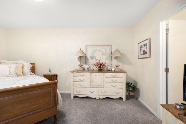 bedroom with dark colored carpet