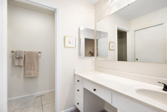 bathroom with tile patterned floors and vanity