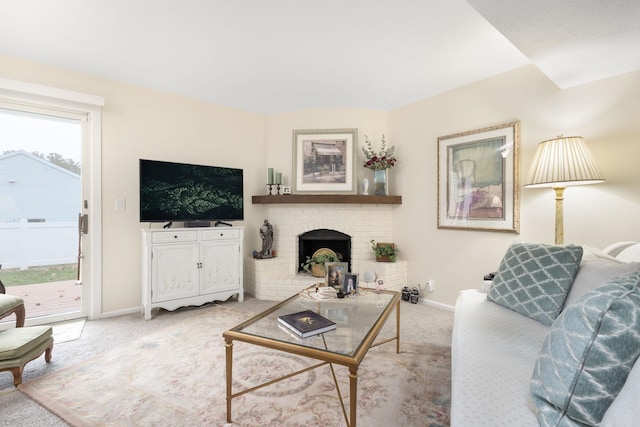 living room with a fireplace, light colored carpet, and a healthy amount of sunlight