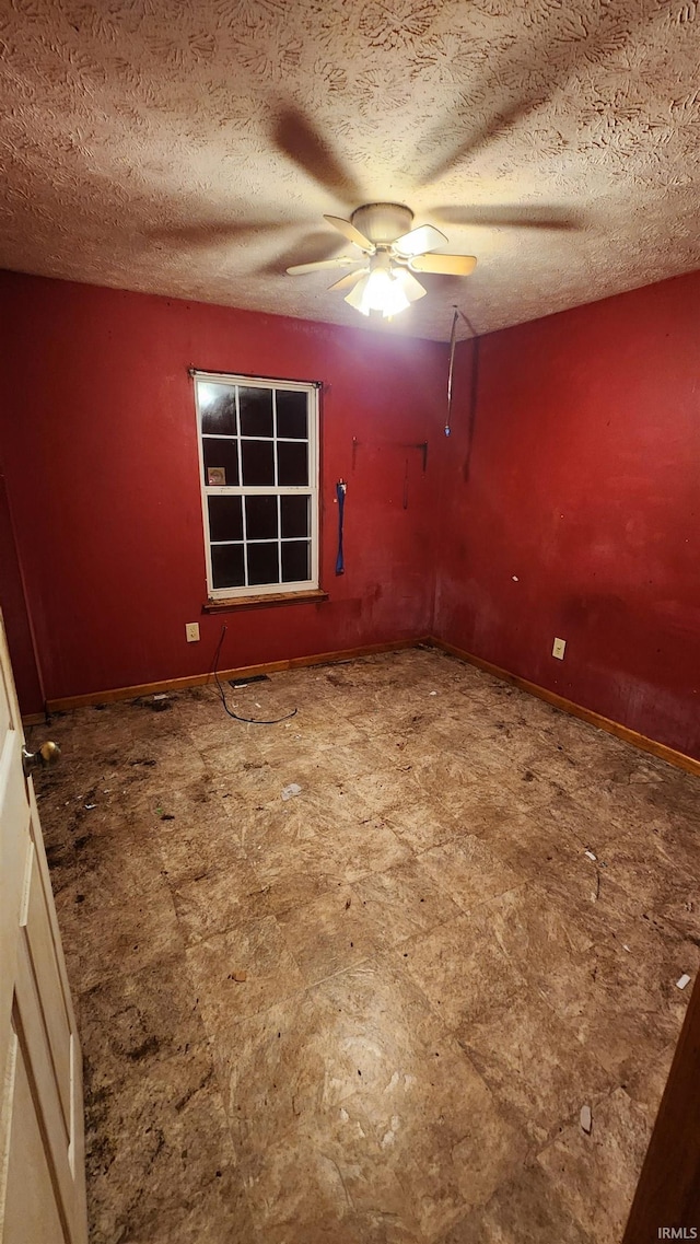 unfurnished room with a textured ceiling