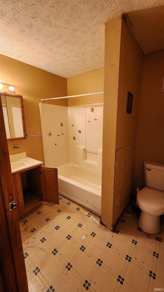 full bathroom featuring vanity, a textured ceiling, shower / bath combination, and toilet