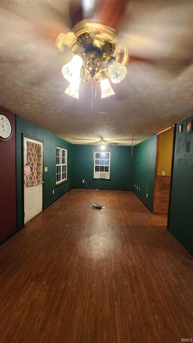 empty room with a textured ceiling and hardwood / wood-style flooring