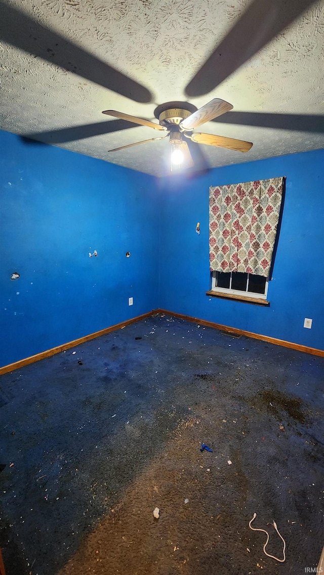 empty room with carpet and a textured ceiling