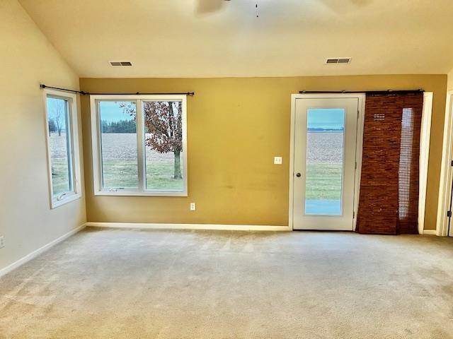 carpeted spare room with ceiling fan