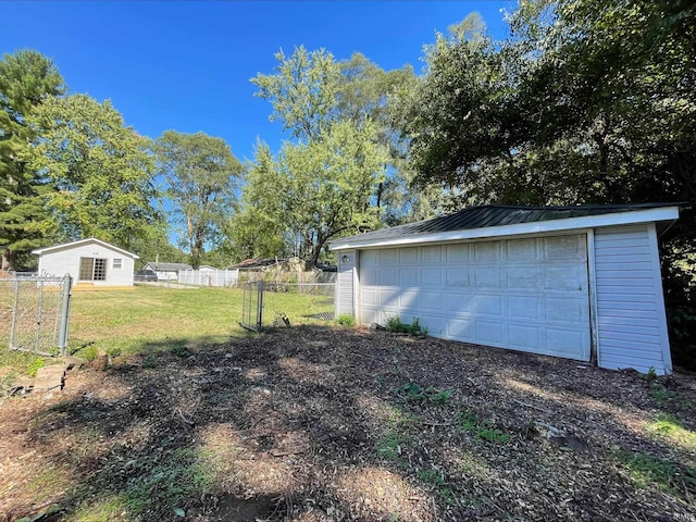 view of yard with a garage and an outdoor structure