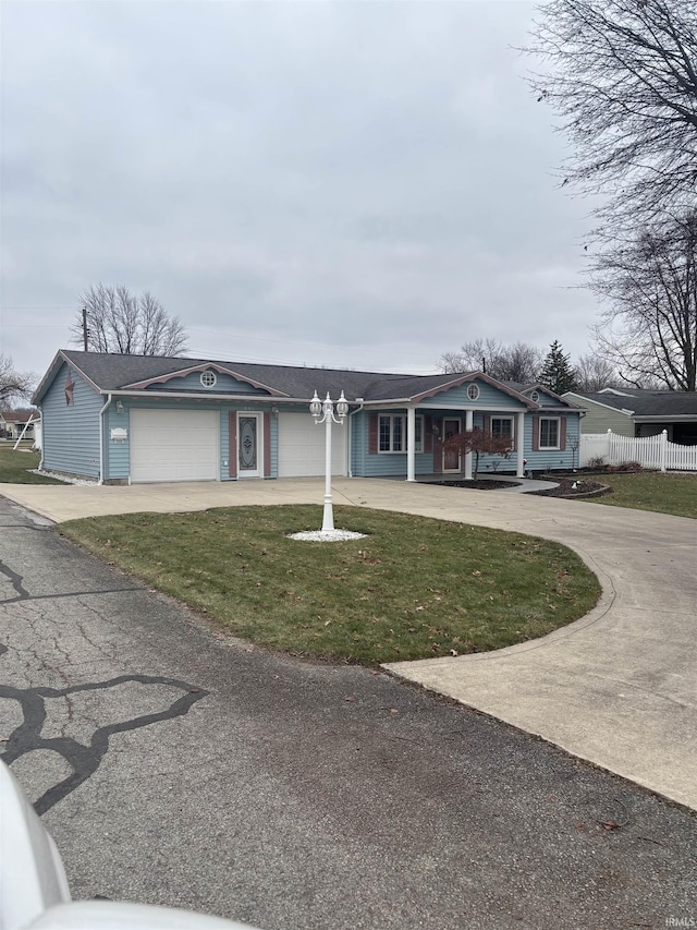 single story home featuring a front lawn and a garage