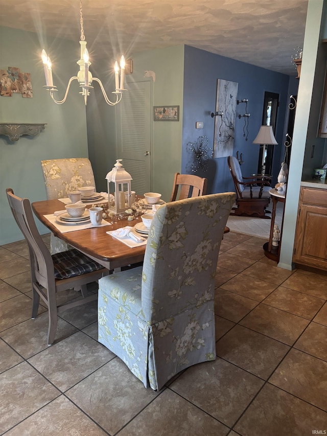 dining room with tile patterned flooring and a notable chandelier