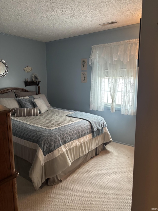 bedroom with carpet and a textured ceiling