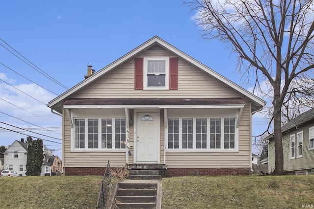 bungalow-style house with a front yard