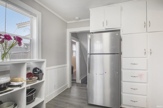 kitchen featuring white cabinets, stainless steel fridge, dark hardwood / wood-style floors, and crown molding