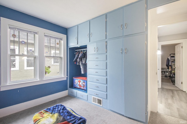 mudroom with light hardwood / wood-style floors