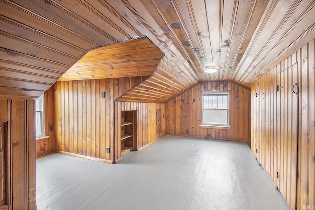 additional living space featuring wood walls, light wood-type flooring, wood ceiling, and vaulted ceiling