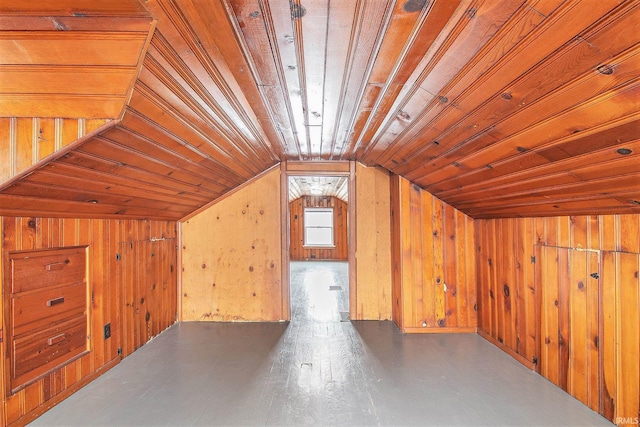 bonus room with hardwood / wood-style floors, lofted ceiling, and wood walls