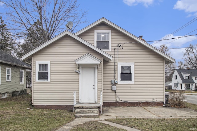 back of property featuring a lawn