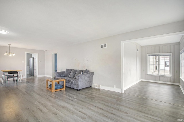 living room with hardwood / wood-style floors and a chandelier