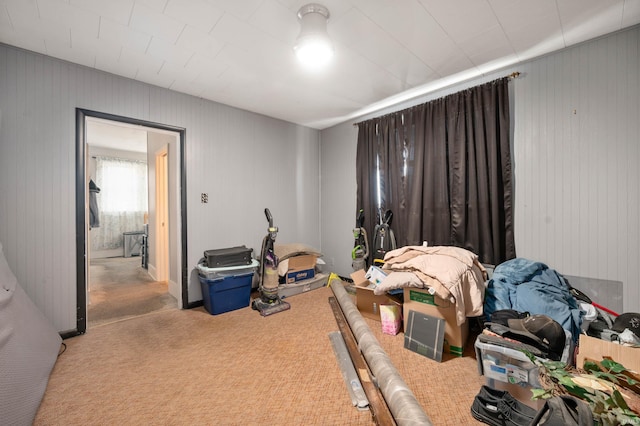 bedroom featuring carpet and wooden walls