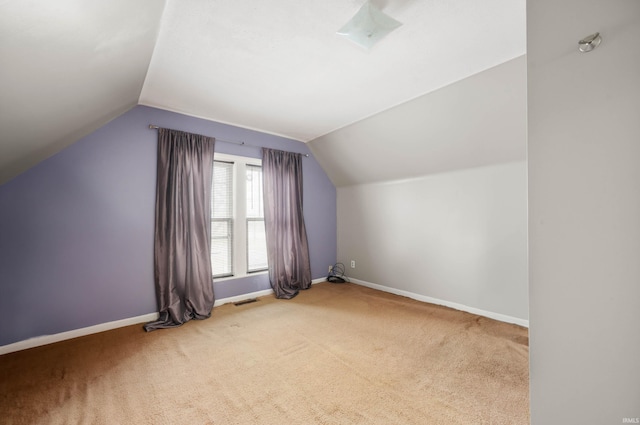 bonus room with carpet floors and lofted ceiling