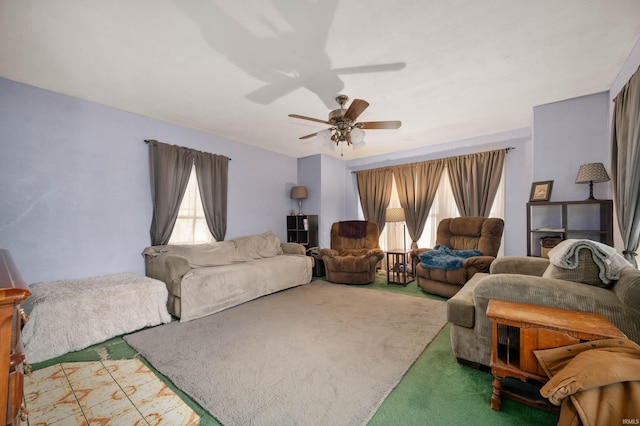 carpeted living room with ceiling fan