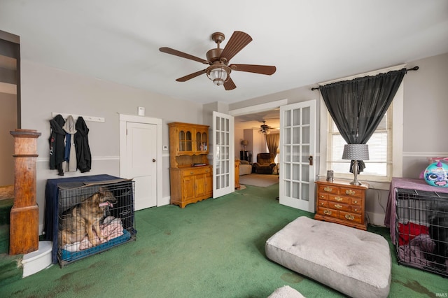 interior space featuring ceiling fan, french doors, and dark carpet