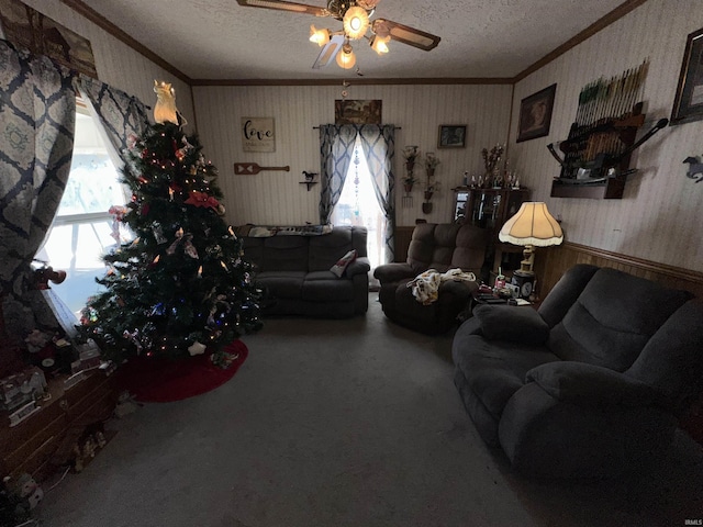 living room with a wealth of natural light, ceiling fan, and a textured ceiling