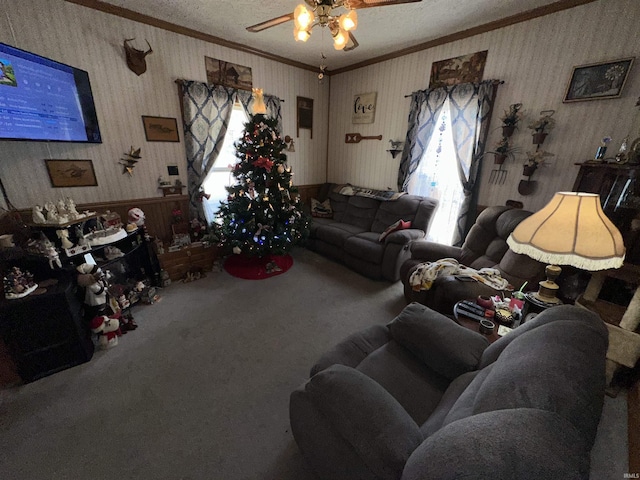 living room with carpet, ceiling fan, crown molding, and a wealth of natural light