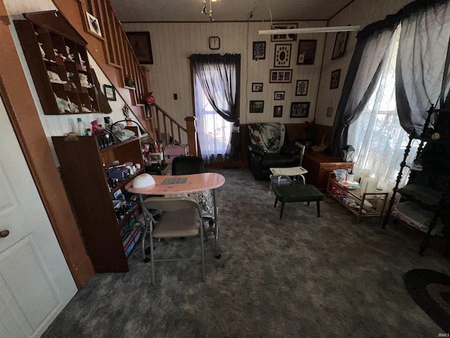 living area with dark colored carpet