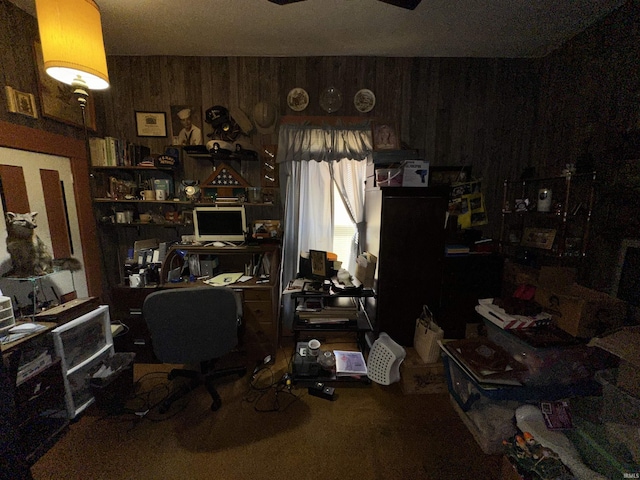 carpeted office featuring wooden walls