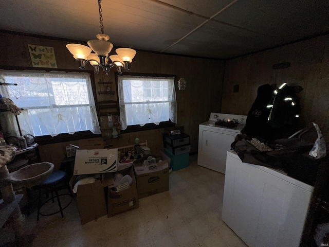 laundry room featuring wooden walls and a notable chandelier