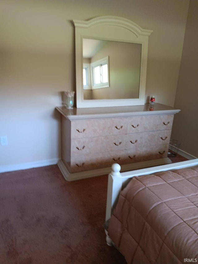 unfurnished bedroom with dark colored carpet