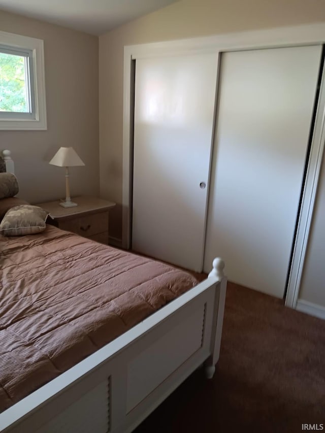 bedroom featuring dark colored carpet