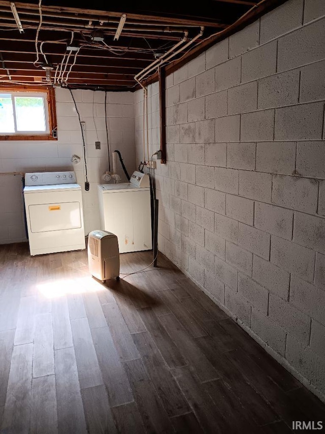 washroom featuring dark hardwood / wood-style flooring and washing machine and dryer